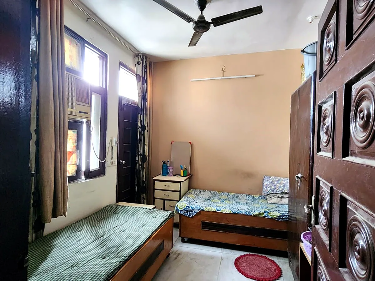 Room with carved door at PG for Girls in Rohini